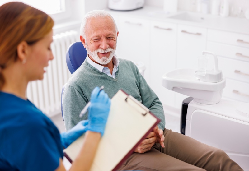A dentist explaining to an elderly patient the link between gum health & diabetes in Warrenville, IL