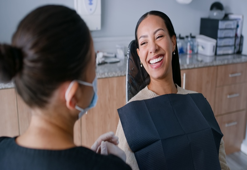 Dentist explains oral health impacts to a patient during a dental clinic visit in Warrenville, IL
